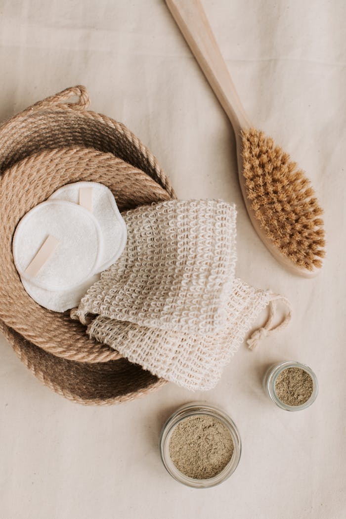 Natural skincare products including brush, cotton pads, and jute basket for zero waste living.